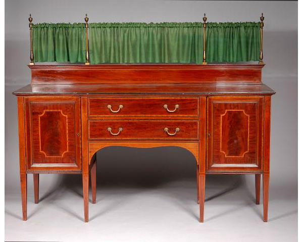 An Edwardian mahogany and crossbanded breakfront sideboard by Maple and Co.,