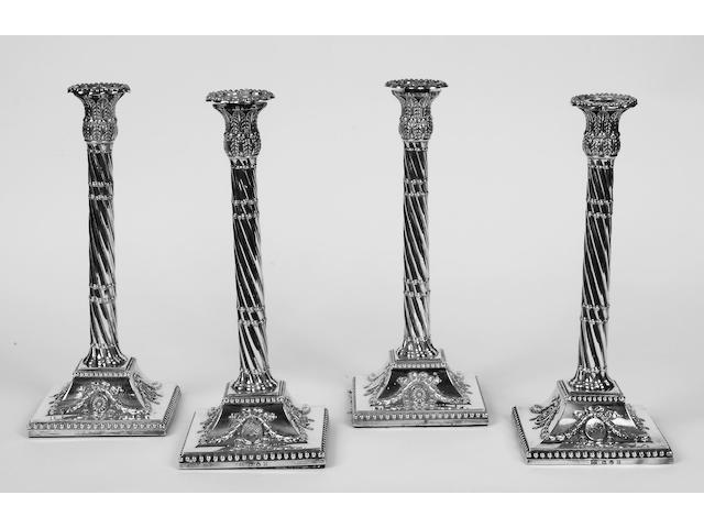 A set of four George III silver candlesticks,