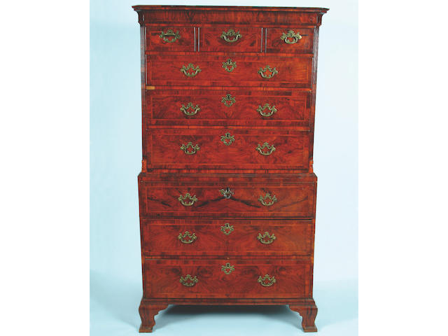 A George I style walnut crossbanded and featherstrung secretaire chest on chest,