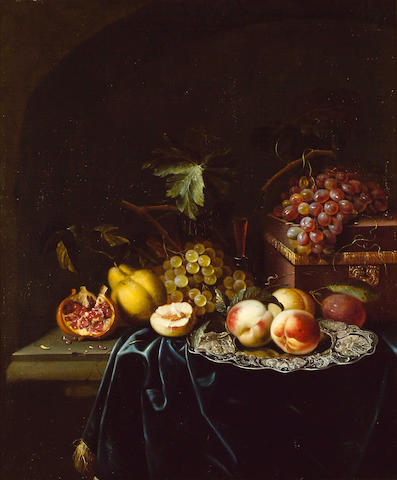 Johannes Borman (active Leiden 1653-1659) Peaches on a salver with a pomegranate, grapes, a pear and a wine glass, with a casket and grapes on a draped ledge 76.5 x 64 cm. (30 &#188; x 25 &#188; in.)