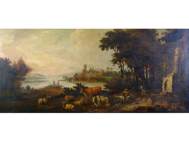 Circle of Adriaen van Diest  A wooded river landscape with peasants and their livestock resting near classical ruins, a fortress on an embankment in the distance 55 x 118.5 cm.