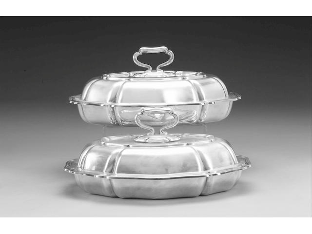 A matched pair of silver shaped oval entr&#233;e dishes and covers, by Atkin Bros., Sheffield 1934 / 1935, weight 112oz.