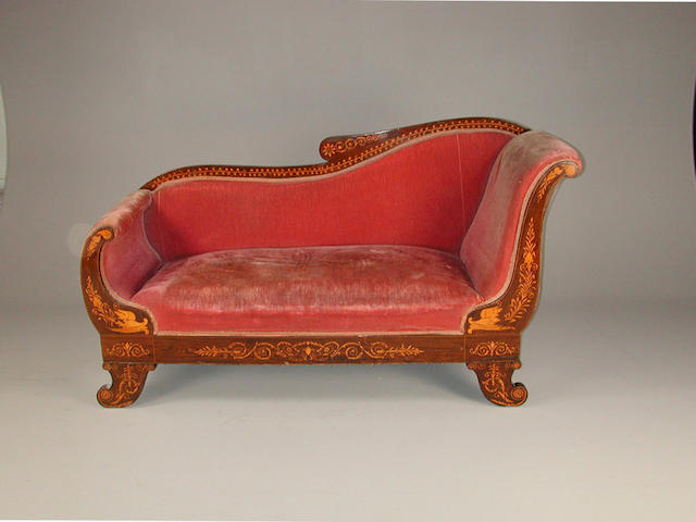 An early 19th century North European rosewood and marquetry chaise longue, with scrolled arms and feet, inlaid with foliate scrolls...