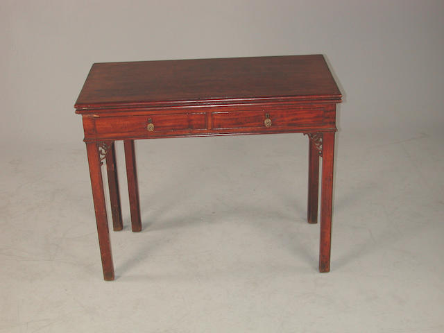 A George III mahogany fold over tea table with two frieze drawers and open fret carving, 92cms wide