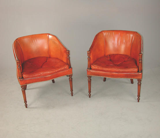 A set of six mahogany framed tub shaped chairs upholstered in orange close buttoned hid