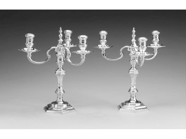 A pair of 18th century style cast silver three-light candelabra, by R. Comyns, London 1972,