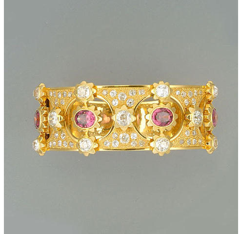 A garnet and diamond hinged bangle