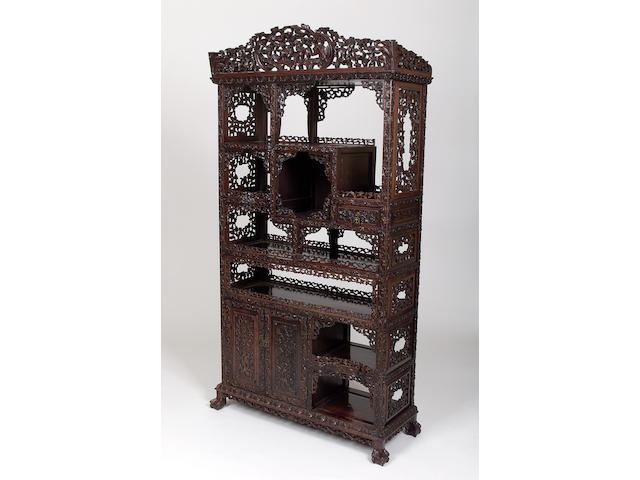 A Chinese carved hardwood open display cabinet,