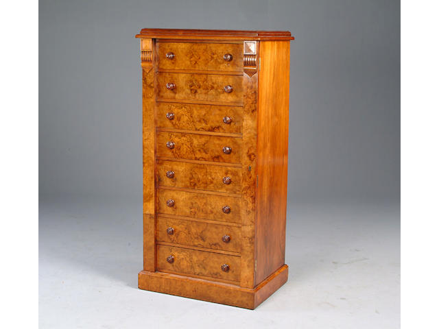 A Victorian walnut wellington chest of eight burr faced drawers.