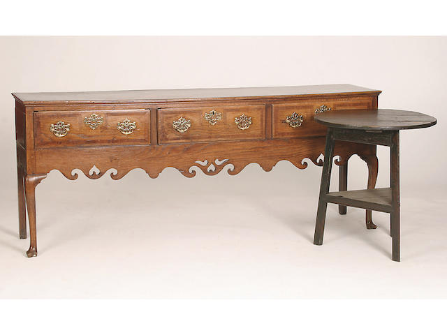 A late 18th Century oak and mahogany crossbanded low dresser,