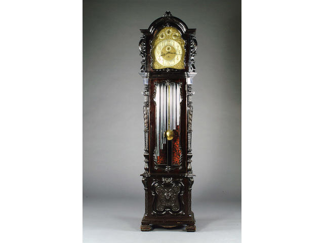 A Late Victorian carved and ebonised longcase clock