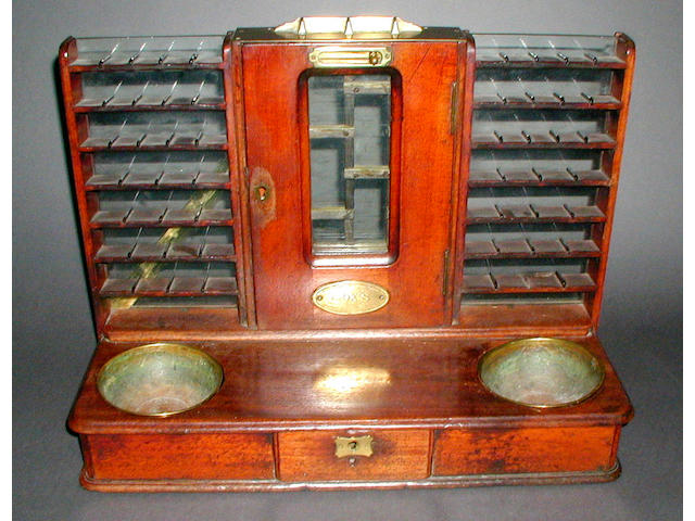 A late 19th/early 20th Century mahogany and brass vending coin change machine,