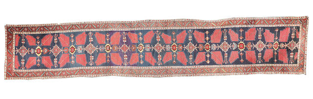A North West Persian runner, 16 ft 9 in x 3 ft 4 in (510 x 101 cm)