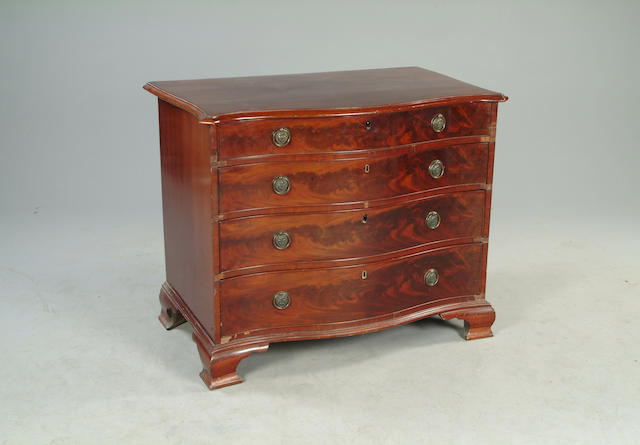 A George III style mahogany serpentine chest