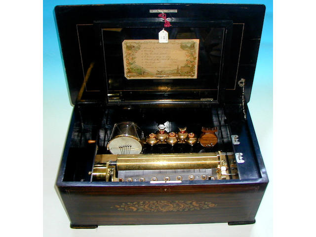 An Ami Rivenc drum, castanet and bells in view musical box,