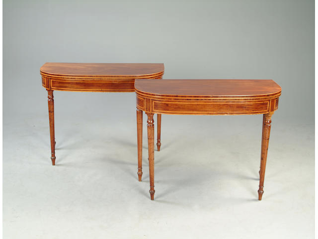 A pair of George III mahogany tea or games tables