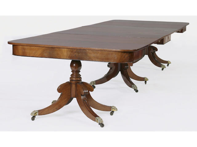 A late George III mahogany triple pedestal dining table,