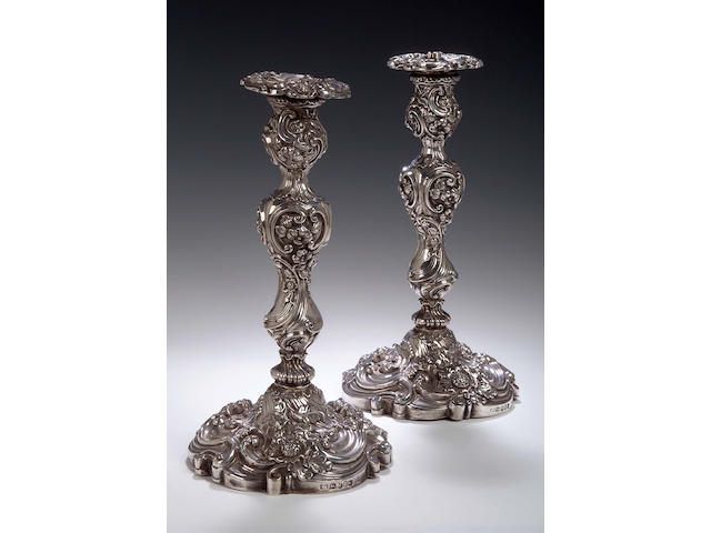 A pair of George III Candlesticks, makers mark of Kirby, Waterhouse & Co, Sheffield 1819 (one sconce 1811) loaded