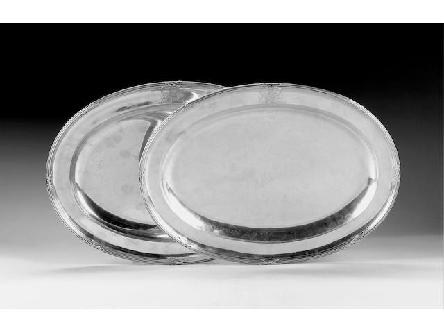 A matched pair of George III oval meat dishes, one by Benjamin Laver, London 1785, the other by William Hall, London 1800,