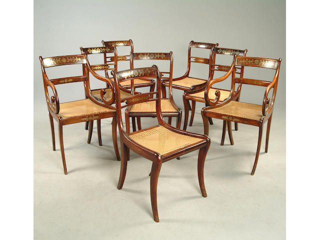 A set of eight Regency rosewood and brass inlaid dining chairs