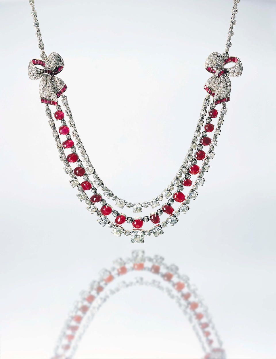 An art deco ruby and diamond festoon necklace
