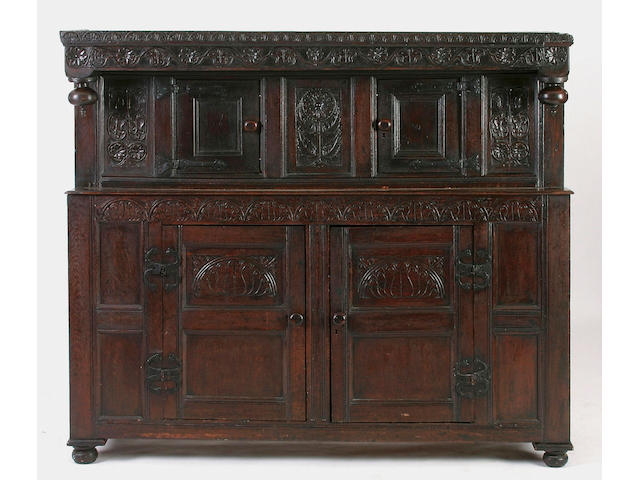 A late 17th Century carved and panelled oak court cupboard,