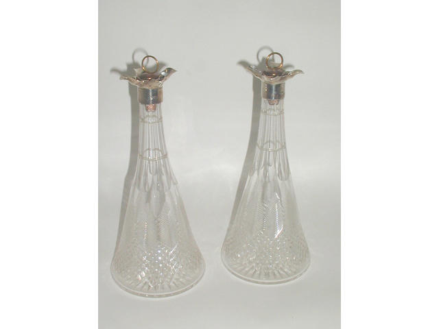 A pair of mounted cut glass decanters,