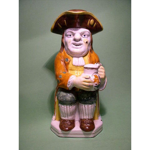 A Staffordshire toby jug and cover,