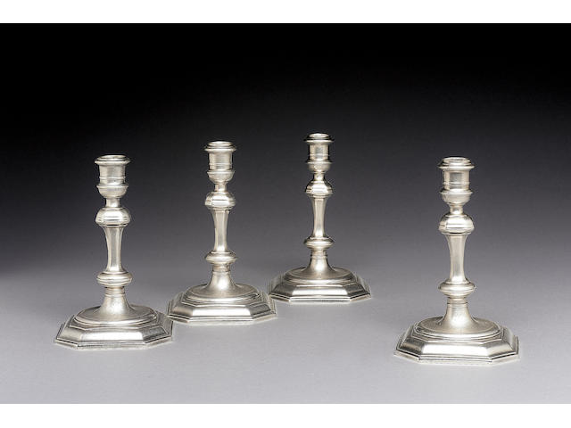 A matched set of four George I/II octagonal cast candlesticks by William Lukin (I), one pair 1726, the other pair 1729,