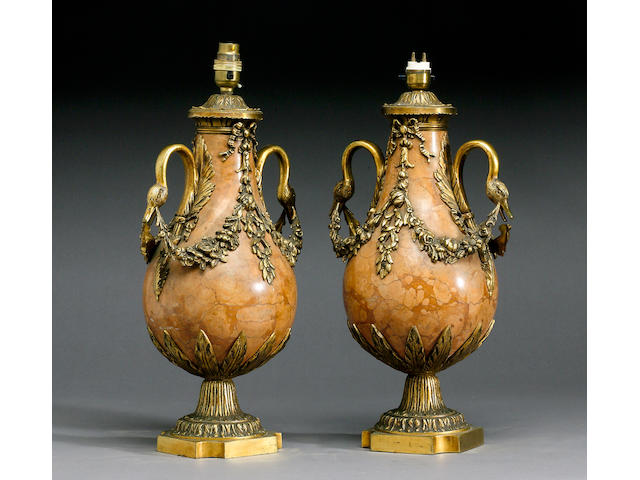 A pair of gilt bronze mounted rouge de Verone marble urns