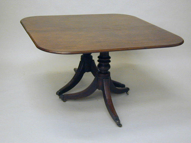 A good early 19th Century mahogany twin pillar dining table,