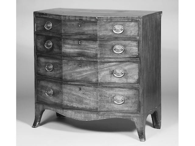 An unusual George III mahogany breakfront serpentine chest,