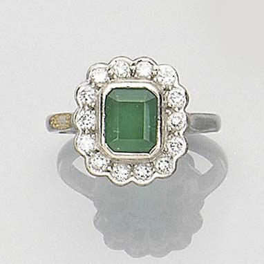 An emerald and diamond cluster ring
