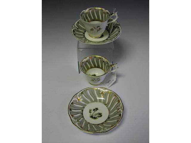 A pair of Rockingham tea cups and saucers,