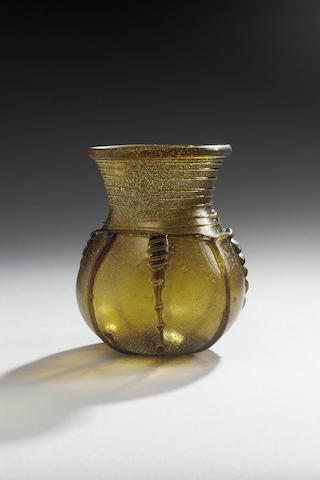 An Anglo-Saxon dark amber green glass globular beaker