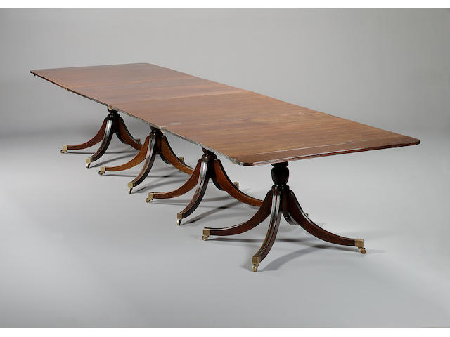 A Regency style mahogany seven pedestal dining table