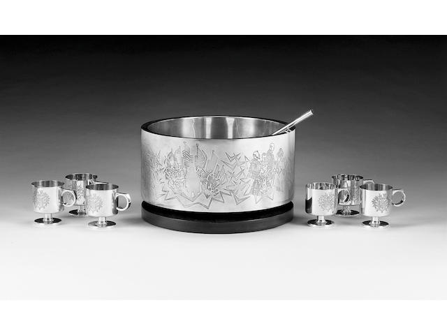A large modern parcel-gilt punch bowl, ladle and six mugs, designed by Alex Styles for Garrard & Co. Ltd., 1973 / 1974 for the centenary of Sir Winston Churchill,