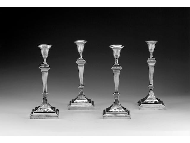 A matched set of four late Victorian silver candlesticks by Messrs. Hutton, London 1899/1901,