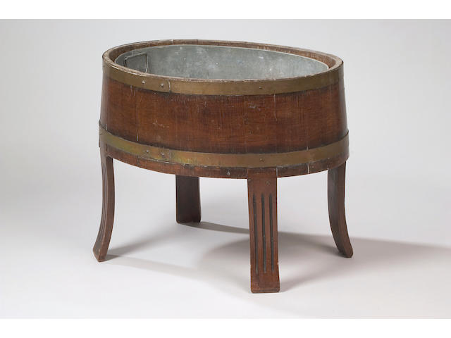 An early 20th Century oak oval coopered jardiniere,