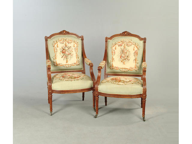 A pair of Louis XVI style carved beech fauteuils