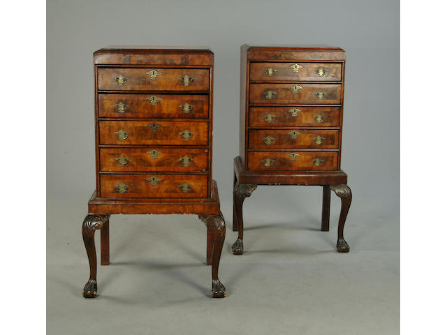 A pair of walnut and cross banded chests on stands