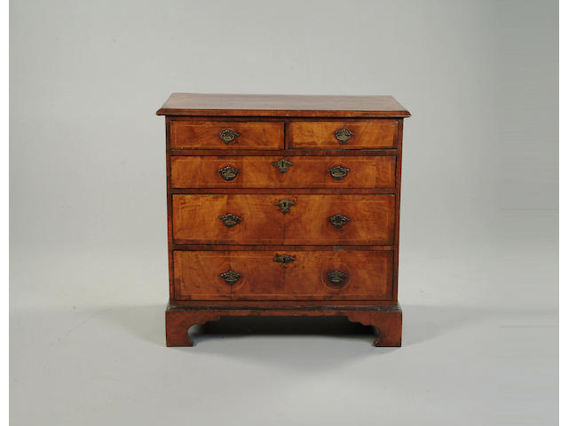 A walnut and boxwood line inlaid chest of drawers