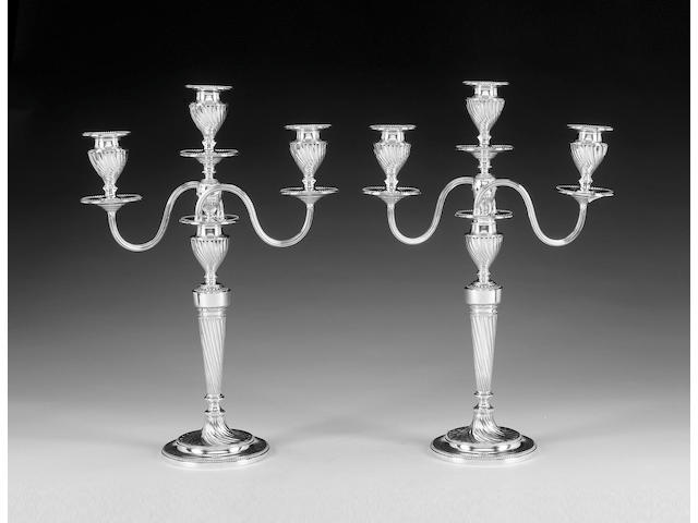 A pair of late Victorian silver three-light candelabra, by Hawksworth, Eyre & Co. Ltd., Sheffield 1890,