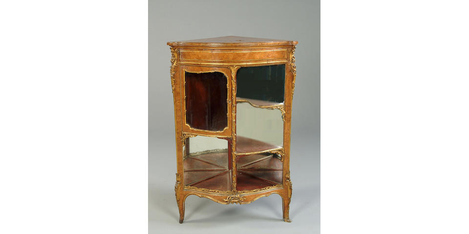 A late 19th/early 20th century burr elm and gilt metal mounted bow front encoignure