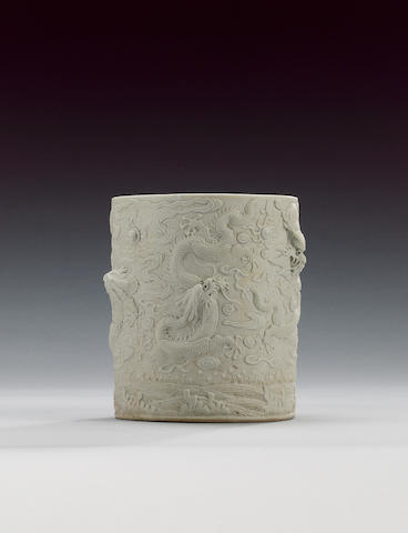 A white monochrome cylindrical brushpot,