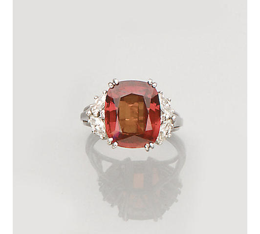 An orange sapphire and diamond ring