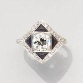 A diamond and onyx plaque ring