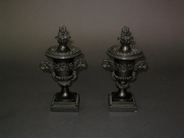 A pair of Regency patinated bronze pot pourri mantel urns,