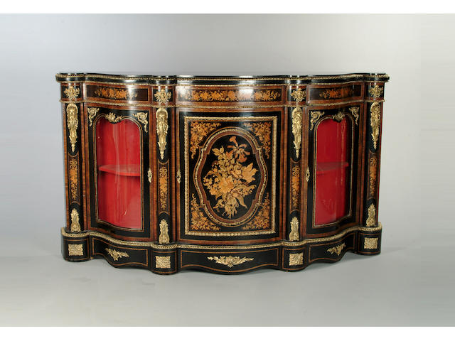 A Victorian ebonised, walnut, marquetry and gilt metal mounted serpentine credenza