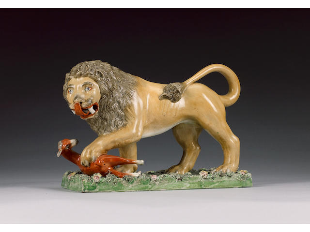 A large pearlware model of a lion and deer, circa 1820-30,